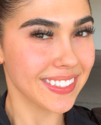 a close up of a woman smiling for the camera